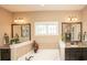 Inviting bathroom featuring a large soaking tub, double vanity, and neutral color scheme at 304 San Martin Ct., Longs, SC 29568