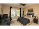 Comfortable bedroom with window view, desk, dark accents, and ceiling fan, offering a serene retreat at 304 San Martin Ct., Longs, SC 29568