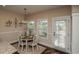 Bright breakfast nook features a round table with seating for four and view to pool area at 304 San Martin Ct., Longs, SC 29568