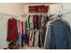 Organized walk-in closet with shelving and hanging rods for optimal storage in a neutral-toned room at 304 San Martin Ct., Longs, SC 29568