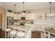 Open kitchen features granite countertops, stainless steel appliances, white cabinets and hardwood floors at 304 San Martin Ct., Longs, SC 29568