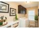 Well-lit laundry room with modern washer, dryer, ample cabinetry, and decor for a functional and stylish space at 304 San Martin Ct., Longs, SC 29568