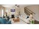 Open-concept living room with fireplace, comfortable seating, and staircase access at 304 San Martin Ct., Longs, SC 29568