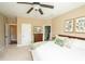 Cozy main bedroom with a ceiling fan, neutral walls, and multiple entry doors at 304 San Martin Ct., Longs, SC 29568