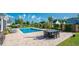 Enjoy the beautiful pool area with lounge chairs, umbrella-covered table with chairs and well-manicured landscaping at 304 San Martin Ct., Longs, SC 29568