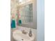 Close-up of powder room featuring decorative wallpaper, framed mirror, and stylish sink at 304 San Martin Ct., Longs, SC 29568