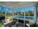 Relaxing screened porch with comfortable seating overlooking a sparkling pool and beautifully landscaped backyard at 304 San Martin Ct., Longs, SC 29568