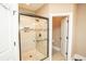 Modern walk-in shower with glass door, tile surround, and convenient grab bar at 304 San Martin Ct., Longs, SC 29568