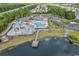 A high-angle aerial of the pool area including a water park, clubhouse, lake, and pier at 3119 Hannon Dr., Myrtle Beach, SC 29579