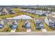 Expansive aerial view of a residential community featuring numerous homes surrounding a serene pond and lush green spaces at 3119 Hannon Dr., Myrtle Beach, SC 29579