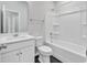 A bright bathroom features white cabinetry, stylish fixtures, and a combination tub and shower at 3119 Hannon Dr., Myrtle Beach, SC 29579
