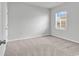 Bright carpeted bedroom with neutral color scheme receives ample natural light from a window with blinds at 3119 Hannon Dr., Myrtle Beach, SC 29579