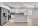 Modern kitchen featuring stainless steel appliances, white cabinetry, a granite island, and a spacious open floor plan at 3119 Hannon Dr., Myrtle Beach, SC 29579