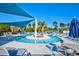 Lazy river swimming pool with shade sails, sun loungers, palm trees and blue skies at 3119 Hannon Dr., Myrtle Beach, SC 29579