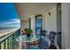 Inviting balcony with chairs, small table, and panoramic ocean views at 3601 S Ocean Blvd. # 8-C, North Myrtle Beach, SC 29582