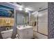 This cozy bathroom features patterned walls, a framed painting, and a glass enclosed shower at 3601 S Ocean Blvd. # 8-C, North Myrtle Beach, SC 29582