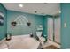 Bright bathroom with a tub, shower and teal accents including towels and wall color at 3601 S Ocean Blvd. # 8-C, North Myrtle Beach, SC 29582