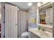 Well-lit bathroom features a sink, toilet and decorative wallpaper plus shower with curtain at 3601 S Ocean Blvd. # 8-C, North Myrtle Beach, SC 29582