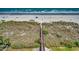 Scenic beach view from above, showcasing a boardwalk and vegetation at 3601 S Ocean Blvd. # 8-C, North Myrtle Beach, SC 29582