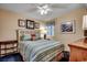 Comfortable bedroom featuring striped bedding, nautical decor and a ceiling fan with overhead lighting at 3601 S Ocean Blvd. # 8-C, North Myrtle Beach, SC 29582