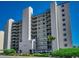 The Beach Club condo building featuring multiple balconies with ocean views and well-manicured landscaping at 3601 S Ocean Blvd. # 8-C, North Myrtle Beach, SC 29582