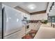 Bright kitchen features white appliances, cabinets and countertops, plus a colorful rug and warm, wood-look accents at 3601 S Ocean Blvd. # 8-C, North Myrtle Beach, SC 29582