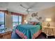 Serene main bedroom featuring ocean views, balcony access, coastal decor and a ceiling fan at 3601 S Ocean Blvd. # 8-C, North Myrtle Beach, SC 29582