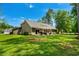 Expansive backyard with lush lawn, patio, and outdoor seating, perfect for entertaining and relaxation at 370 Foxtail Dr., Longs, SC 29568