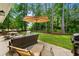 Inviting outdoor patio featuring lounge seating, dining table and expansive backyard at 370 Foxtail Dr., Longs, SC 29568