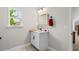 Bathroom with white vanity, black hardware, and a large window for natural light at 370 Foxtail Dr., Longs, SC 29568