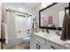 Well-lit bathroom with a white vanity, black hardware, and a shower-tub combo at 370 Foxtail Dr., Longs, SC 29568