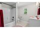 Bright bathroom featuring a shower-tub, black fixtures, and a vanity with a window view at 370 Foxtail Dr., Longs, SC 29568