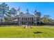 Clubhouse exterior with manicured lawn, flags, and statue of a golfer in action at 370 Foxtail Dr., Longs, SC 29568