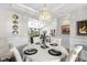 Open-concept dining room features modern chandelier and seamless flow to the living area at 370 Foxtail Dr., Longs, SC 29568