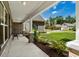Inviting front porch with brick columns, bench seating, and manicured landscaping at 370 Foxtail Dr., Longs, SC 29568
