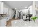 Open kitchen featuring granite counters, stainless appliances, and adjacent staircase at 370 Foxtail Dr., Longs, SC 29568