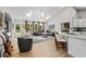 Light-filled living area with a large sectional sofa, stylish chandelier, and cozy decor at 370 Foxtail Dr., Longs, SC 29568