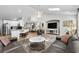 Open-concept living space featuring a large sofa, kitchen bar, and bright, airy design at 370 Foxtail Dr., Longs, SC 29568