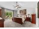 Bright main bedroom with a ceiling fan, neutral colors, and sliding glass doors that lead to the backyard at 370 Foxtail Dr., Longs, SC 29568