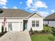 Charming single-story home with a blue front door, attached garage, manicured lawn, and lovely landscaping at 3766 Bells Lake Circle # 3766, Longs, SC 29568