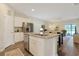 Lovely Kitchen featuring an island with a sink and breakfast bar and view to a comfortable living space at 3766 Bells Lake Circle # 3766, Longs, SC 29568