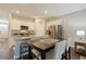 Modern kitchen with granite countertops, stainless steel appliances, white cabinetry, island seating, and hardwood floors at 3766 Bells Lake Circle # 3766, Longs, SC 29568