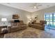 Inviting living room with hardwood floors, comfortable seating, ceiling fan, and sliding glass doors to patio at 3766 Bells Lake Circle # 3766, Longs, SC 29568