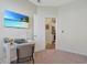 Home office with a desk setup and a large TV, with view of a kitchen through an open door at 3766 Bells Lake Circle # 3766, Longs, SC 29568