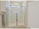 Clean bathroom with a shower featuring a glass door, white tile, and a convenient built in shower seat at 3766 Bells Lake Circle # 3766, Longs, SC 29568