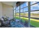 Enclosed sunroom with cozy seating and views of the backyard, perfect for relaxation at 3766 Bells Lake Circle # 3766, Longs, SC 29568