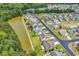 Aerial view of neighborhood featuring mature trees, pond access, and well maintained homes at 389 Barton Loop, Myrtle Beach, SC 29579