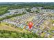 Aerial view of a community with lush green trees, lakes, and homes at 389 Barton Loop, Myrtle Beach, SC 29579