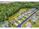 Neighborhood aerial view showing homes near a serene lake surrounded by lush greenery and trees at 389 Barton Loop, Myrtle Beach, SC 29579