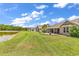 View of the well maintained backyard overlooking a lake with several homes visible in the distance at 389 Barton Loop, Myrtle Beach, SC 29579